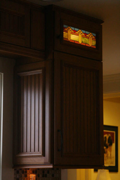 Stained glass mosaic cabinets created for a dairy farm in Pennsylvania.  Design inspired by existing antique stained glass window, and glass from cow backsplash.